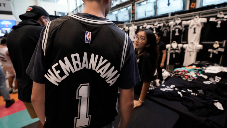 Fans line up to purchase San Antonio Spurs jerseys and T-shirts featuring Victor Wembanyama, the team's first-round pick in the NBA basketball draft, following a watch party at AT&T Center in San Antonio, Thursday, June 22, 2023. (AP)