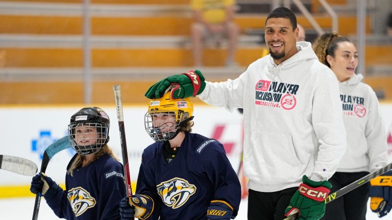 Minnesota Wild hockey player Ryan Reaves, right, of the NHL Player Inclusion Coalition pats Hayden Spalin on the head during a youth hockey clinic with NHL top draft prospects and members of the coalition, Tuesday, June 27, 2023, in Nashville, Tenn.(George Walker IV/AP)