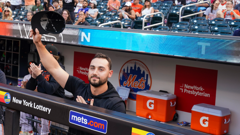 San Francisco Giants right fielder and former New York Mets player Michael Conforto acknowledges the fans' applause as he is introduced on the large television, before a baseball game Friday, June 30, 2023, in New York. (AP Photo/Mary Altaffer)