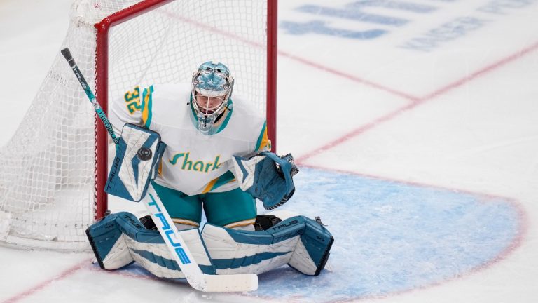 San Jose Sharks goaltender Eetu Makiniemi deflects a Vancouver Canucks shot during the third period of an NHL hockey game in San Jose, Calif., Wednesday, Dec. 7, 2022. Makiniemi made his NHL debut in the game. (Godofredo A. Vásquez/AP)