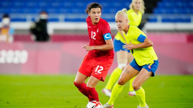 Canada's Christine Sinclair dribbles the ball in front of Sweden's Caroline Seger. (Frank Gunn/CP)