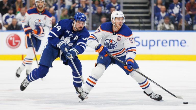 Toronto Maple Leafs centre Auston Matthews (34) chases Edmonton Oilers centre Connor McDavid (97) during first period NHL hockey action in Toronto on Saturday, March 11, 2023. (Cole Burston/CP)