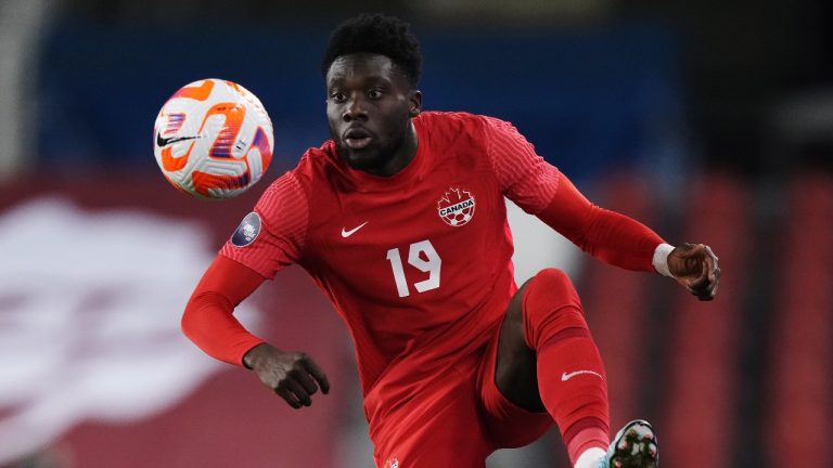 Canada midfielder Alphonso Davies (19) controls the ball against Honduras during first half Concacaf Nations League soccer action in Toronto. (Nathan Denette/CP)