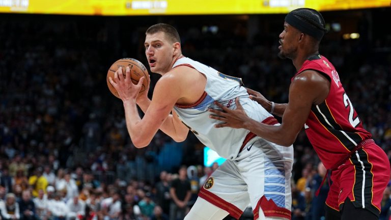 Denver Nuggets center Nikola Jokic, left, is defended by Miami Heat forward Jimmy Butler, right, during the second half of Game 5 of basketball's NBA Finals, Monday, June 12, 2023, in Denver. (Jack Dempsey/AP)