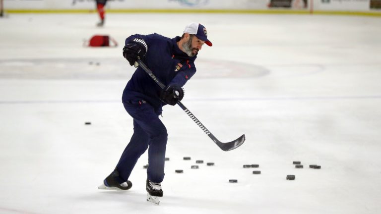 Former Florida Panthers assistant coach Derek MacKenzie takes a shot as players run through drills during an NHL hockey training camp, Wednesday, July 22, 2020, at the Panther's training facility in Coral Springs, Fla. (Wilfredo Lee/AP)