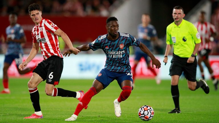 Brentford's Christian Norgaard vies for the ball with Arsenal's Folarin Balogun, center, during the English Premier League soccer match between Brentford and Arsenal at the Brentford Community Stadium in London, England, Friday, Aug. 13, 2021. (Ian Walton/AP)