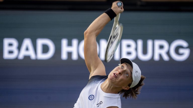 Poland's Iga Swiatek serves to German Tatjana Maria during their first round WTA tour tennis match in Bad Homburg, Germany, Monday, June 26, 2023. (AP)