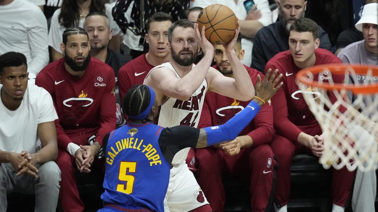 Denver Nuggets guard Kentavious Caldwell-Pope (5) defends Miami Heat forward Kevin Love (42) during the first half of Game 3 of the NBA Finals basketball game, Wednesday, June 7, 2023, in Miami. (Rebecca Blackwell/AP)