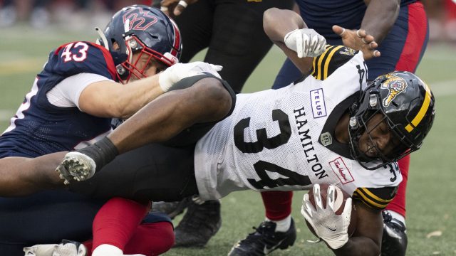 Montreal, Canada. 01st July, 2023. Montreal Alouettes quarterback Cody  Fajardo (7) hands off to running back William Stanback during first half  CFL football action against the Winnipeg Blue Bombers in Montreal, Saturday