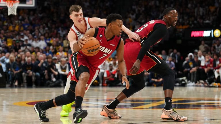 Miami Heat guard Kyle Lowry (7) moves the ball while defended by Denver Nuggets guard Christian Braun, rear left, during the first half of Game 5 of basketball's NBA Finals, Monday, June 12, 2023, in Denver. (AP)