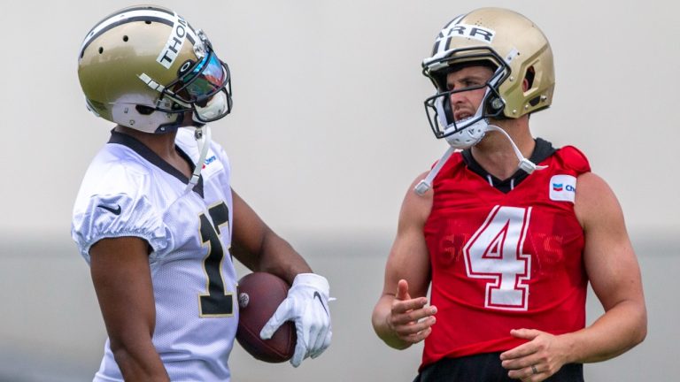 New Orleans Saints wide receiver Michael Thomas (13) talks with quarterback Derek Carr (4) during NFL football practice in Metairie, La., Tuesday, June 6, 2023. (Catie Shea/The Times-Picayune/The New Orleans Advocate via AP)