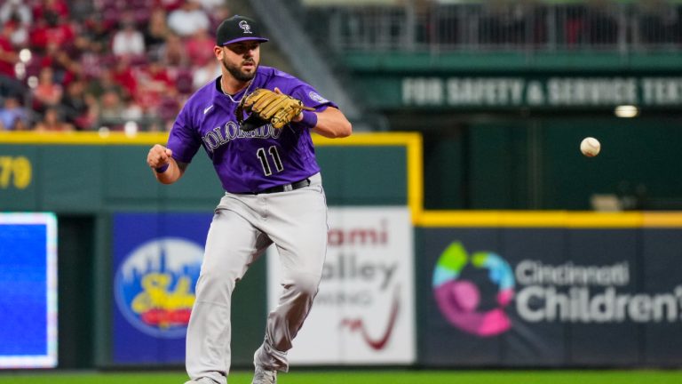 Colorado Rockies' Mike Moustakas fields the ball during a baseball game against the Cincinnati Reds in Cincinnati, Monday, June 19, 2023. (Aaron Doster/AP)