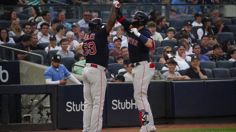 Boston Red Sox's Justin Turner, right, high-fives third base coach Carlos Febles after his solo home run in the second inning of a baseball game against the New York Yankees, Sunday, June 11, 2023, in New York. (Bebeto Matthews/AP)