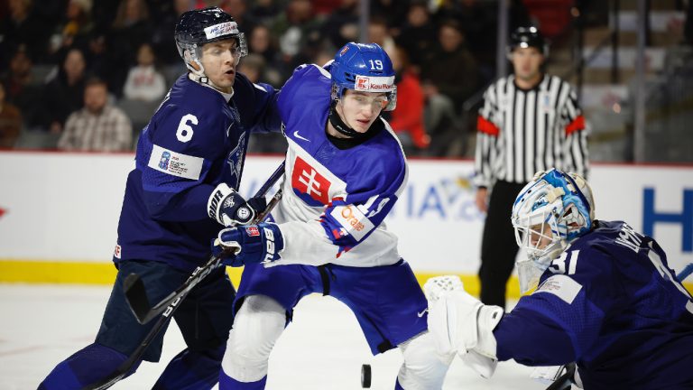 Kalle Ervasti # 6 of team Finland checks Samuel Honzek #19 of team Slovakia in front of Jane Lampinen #31 during the third period during the 2023 IIHF World Junior Championship at Avenir Centre on December 27, 2022 in Moncton, Canada. (Dale Preston/Getty Images)