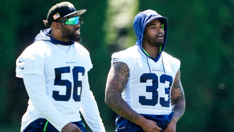 Seattle Seahawks linebacker Jordyn Brooks (56) and safety Jamal Adams (33) talk during NFL football practice, Tuesday, June 6, 2023, at the team's facilities in Renton, Wash. (AP)