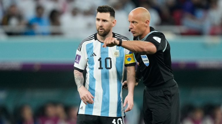 Referee Szymon Marciniak gestures as he speaks with Argentina's Lionel Messi during the World Cup round of 16 soccer match between Argentina and Australia at the Ahmad Bin Ali Stadium in Doha, Qatar, on Dec. 3, 2022.  Polish soccer referee Szymon Marciniak has apologized for speaking at a business event tied to a far-right politician and was confirmed by UEFA to officiate next week's Champions League final. Marciniak’s appointment for the game between Manchester City and Inter Milan on June 10 was at risk. (Jorge Saenz/AP)