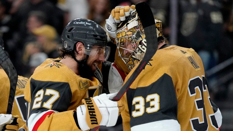 Vegas Golden Knights defenceman Shea Theodore (27) celebrates with goaltender Adin Hill (33) after Game 1 of the NHL hockey Stanley Cup Finals against the Florida Panthers, Saturday, June 3, 2023, in Las Vegas. The Vegas Golden Knights defeated the Panthers 5-2. (John Locher/AP)