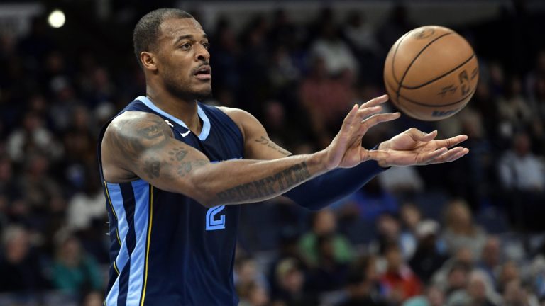 Xavier Tillman (2) passes the ball in the first half of an NBA basketball game against the Orlando Magic Tuesday, March 28, 2023, in Memphis, Tenn. (Brandon Dill/AP)