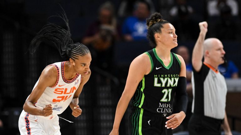 Connecticut Sun forward DeWanna Bonner celebrates after scoring a 3-pointer against Minnesota Lynx guard Kayla McBride during the first half of a WNBA basketball game Thursday, June 1, 2023, in Minneapolis. (Aaron Lavinsky/Star Tribune via AP)