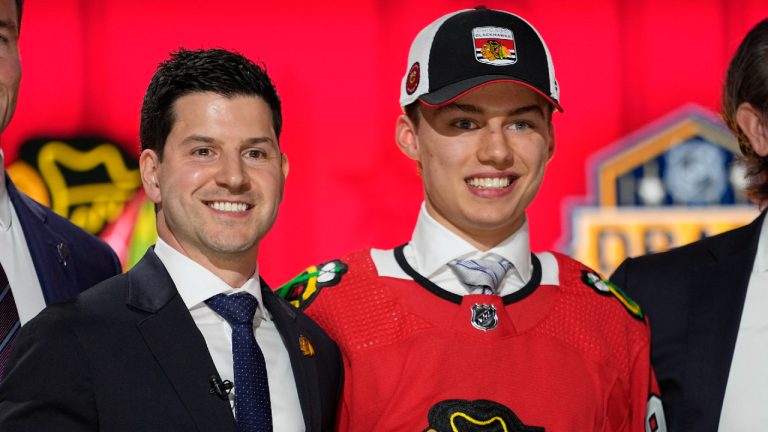 Chicago Blackhawks general manager Kyle Davidson poses with first round draft pick Connor Bedard during the first round of the NHL hockey draft, Wednesday, June 28, 2023, in Nashville, Tenn. (George Walker IV/AP)