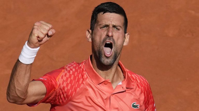 Serbia's Novak Djokovic clenches his fist after scoring a point against Spain's Carlos Alcaraz during their semifinal match of the French Open tennis tournament at the Roland Garros stadium. (Christophe Ena/AP)