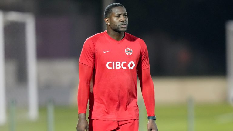 Canada's Doneil Henry an injured defender who's with the team in a non-playing role walks during practice at the World Cup in Doha, Qatar on Tuesday, November 29, 2022. (Nathan Denette/CP)