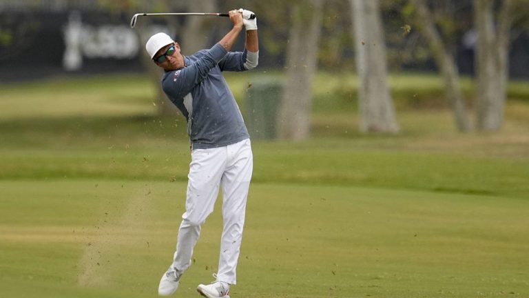 Rickie Fowler hits from the fairway on the second hole during the first round of the U.S. Open golf tournament at Los Angeles Country Club. (George Walker IV/AP)
