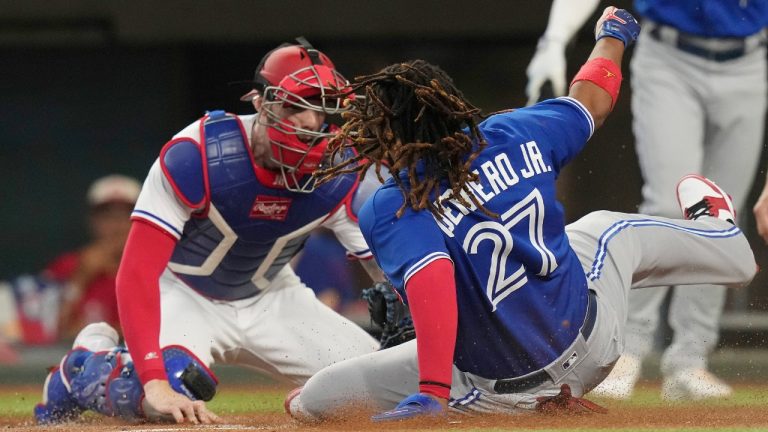 Toronto Blue Jays' Vladimir Guerrero Jr. (27) is tagged out at home plate by Texas Rangers catcher Jonah Heim during the first inning of a baseball game in Arlington, Texas, Saturday, June 17, 2023. Guerrero was trying to score from second base on a single by Blue Jays Daulton Varsho. (LM Otero/AP)