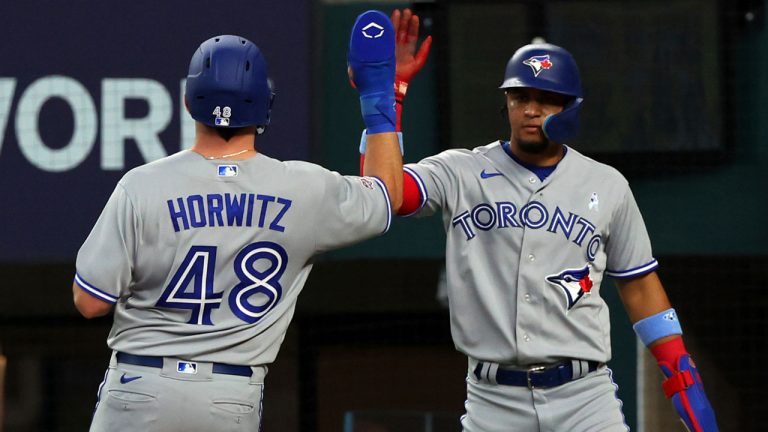 Toronto Blue Jays Spencer Horwitz (48) celebrates with Santiago Espinal, right, after scoring on a single by Whit Merrifield in the second inning in a baseball game. (Richard W. Rodriguez/AP)