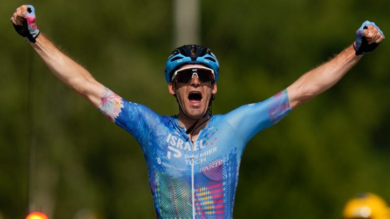 Stage winner Hugo Houle of Canada celebrates as he crosses the finish line during the sixteenth stage of the Tour de France cycling race over 178.5 kilometers (111 miles) with start in Carcassonne and finish in Foix, France, Tuesday, July 19, 2022. Canadians Michael Woods, Houle and Guillaume Boivin will ride together in Israel-Premier Tech's entry for the Tour de France. (Thibault Camus/AP)