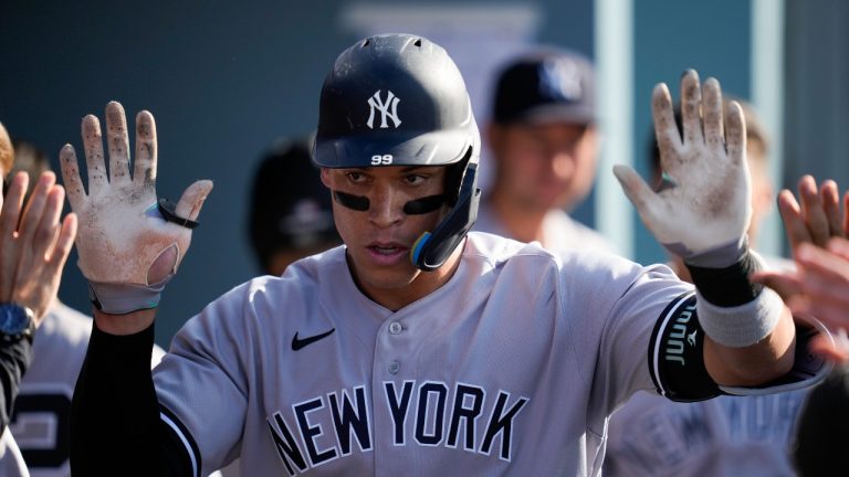 New York Yankees' Aaron Judge (99) celebrates in the dugout after hitting a home run during the sixth inning of a baseball game against the Los Angeles Dodgers in Los Angeles, Saturday, June 3, 2023. (Ashley Landis/AP Photo)