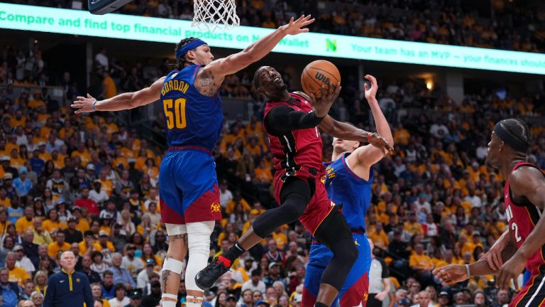 Miami Heat center Bam Adebayo, center, shoots while defended by Denver Nuggets forward Aaron Gordon (50) and center Nikola Jokic during the second half of Game 1 of basketball's NBA Finals, Thursday, June 1, 2023, in Denver. (Jack Dempsey/AP)