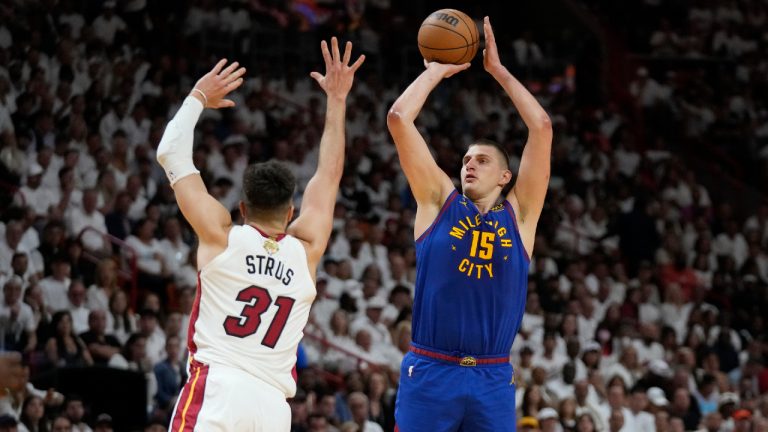 Denver Nuggets center Nikola Jokic (15) aims to score as Miami Heat guard Max Strus (31) defends during the first half of Game 3 of the NBA Finals basketball game, Wednesday, June 7, 2023, in Miami. (Wilfredo Lee/AP)