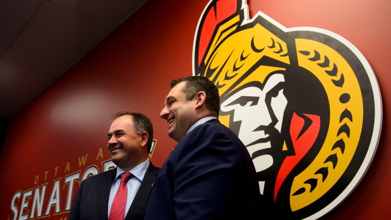 Senators coach D.J. Smith, right, and general manager Pierre Dorion. (CP)