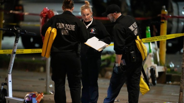 Denver Police Department investigators work the scene of a mass shooting early Tuesday, June 13, 2023, in Denver. Police say several people were wounded in an area where basketball fans had been celebrating the Denver Nuggets first NBA title win. A man who is a suspect was one of the people shot and was taken into custody. (David Zalubowski/AP Photo)