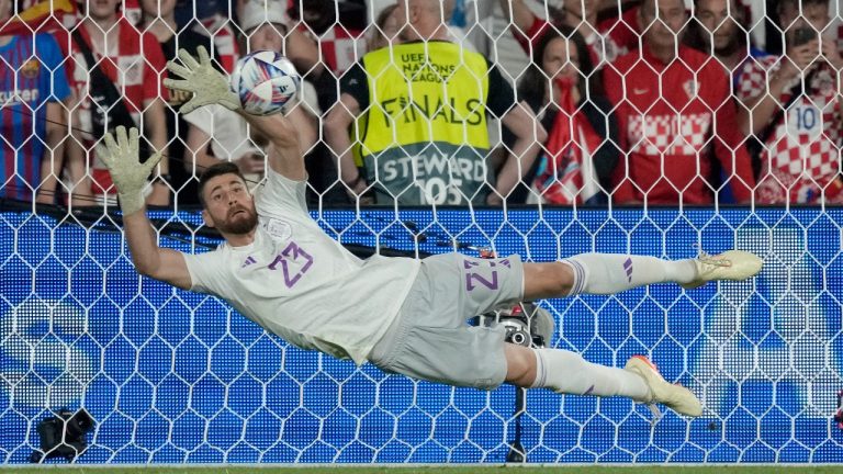 Spain goalkeeper Unai Simon stops a penalty shot from Croatia's Bruno Petkovic during a penalty shootout at the end of the Nations League final soccer match between Croatia and Spain at De Kuip stadium in Rotterdam, Netherlands, Sunday, June 18, 2023. Spain won 5-4 in a penalty shootout after the match ended tied 0-0. (Peter Dejong/AP)