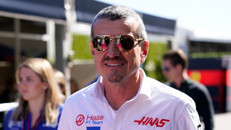 Guenther Steiner, centre, Team Principal of Haas F1 Team, walks through the paddock at the Formula One U.S. Grand Prix auto race at the Circuit of the Americas, Thursday, Oct. 20, 2022, in Austin, Texas. (Charlie Neibergall/AP)