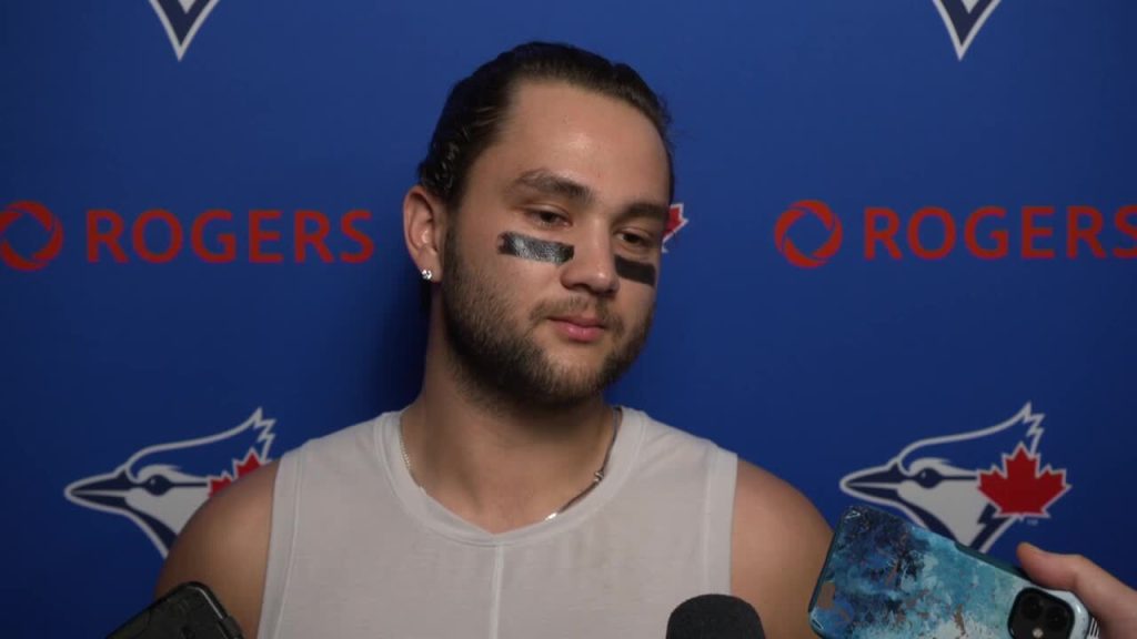 Bo Bichette of the Toronto Blue Jays flicks his hair back after