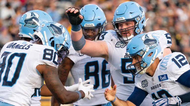 Toronto Argonauts quarterback Chad Kelly (12) congratulates wide receiver DaVaris Daniels (80) after his touchdown against the Hamilton Tiger-Cats during first half CFL football game action in Hamilton, Ont. on Friday, July 21, 2023. (Peter Power/CP)