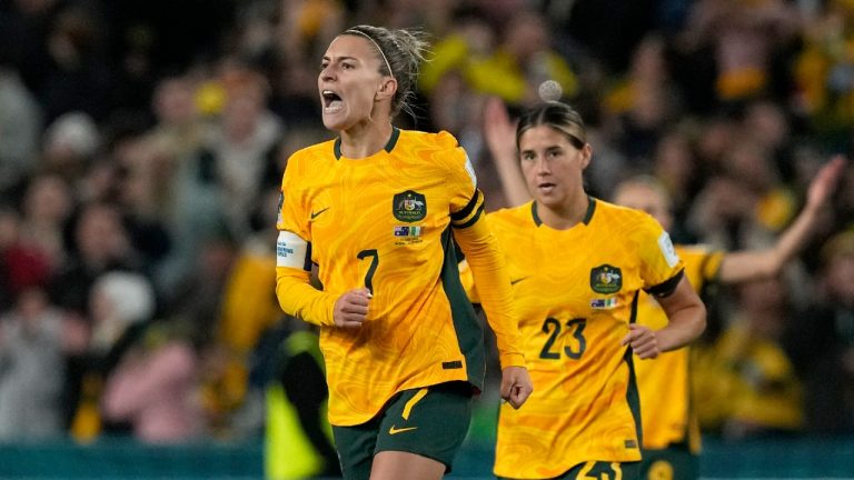 Australia's Steph Catley, left, celebrates after scoring the opening goal from the penalty spot during the Women's World Cup soccer match between Australia and Ireland at Stadium Australia in Sydney, Australia, Thursday, July 20, 2023. (Mark Baker/AP)