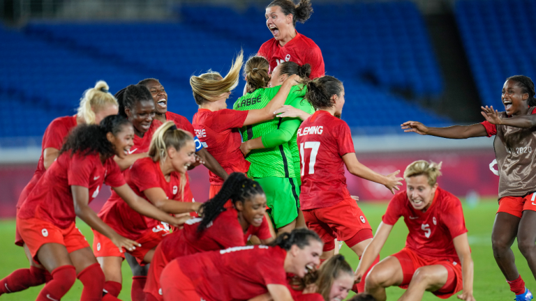 Players of Canada's celebrate beating Sweden in the women's soccer match for the gold medal at the 2020 Summer Olympics, Friday, Aug. 6, 2021, in Yokohama, Japan. (Fernando Vergara/AP)