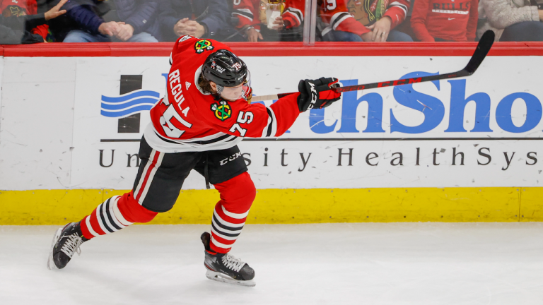 Defenceman Alec Regula (75) shoots and scores against the Calgary Flames during the second period of an NHL hockey game, Monday, April 18, 2022, in Chicago. (AP)