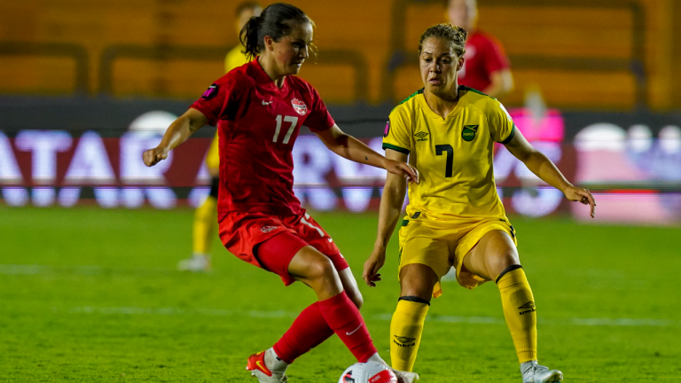 Canada's Jessie Fleming (17) and Jamaica's Chinyelu Asher compete for the ball during a CONCACAF Women's Championship soccer semifinal match in Monterrey, Mexico, Thursday, July 14, 2022. (AP)