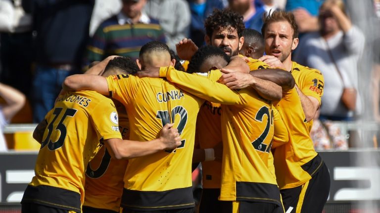 Wolverhampton Wanderers' Matheus Nunes celebrates with teammates after scoring his side's opening goal during the English Premier League soccer match between Wolverhampton Wanderers and Chelsea, at the Molineux Stadium, in Wolverhampton, England, Saturday, April 8, 2023. (AP Photo/Rui Vieira)