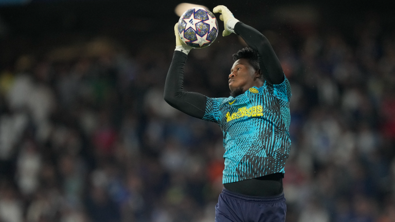 Inter Milan's goalkeeper Andre Onana catches the ball as warming up prior to the Champions League final soccer match between Manchester City and Inter Milan at the Ataturk Olympic Stadium in Istanbul, Turkey, Saturday, June 10, 2023. (AP)