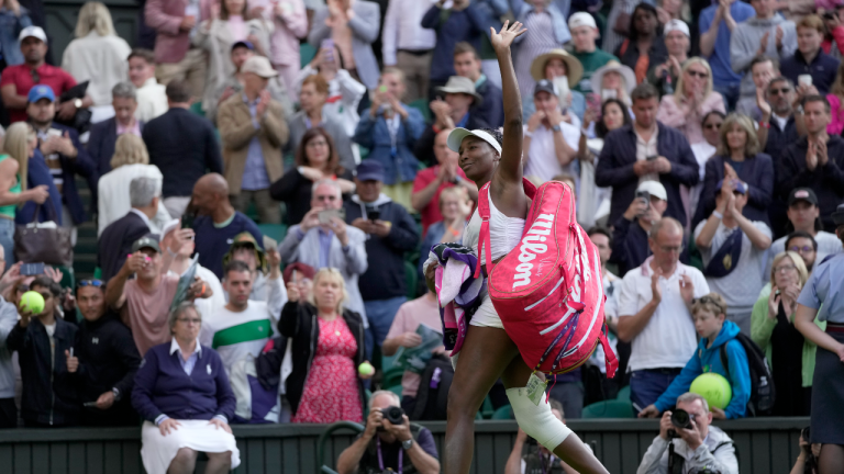 Venus Williams of the US waves as she leaves the court after losing to Ukraine's Elina Svitolina in a first round women's singles match on day one of the Wimbledon tennis championships in London, Monday, July 3, 2023. (AP)