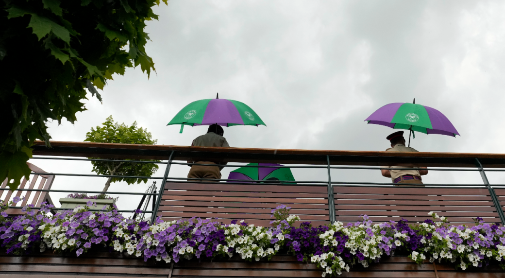 Rain affects play at Wimbledon but matches go ahead under roof on Centre Court