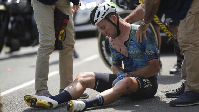 Britain's Mark Cavendish receives medical assistance after crashing during the eighth stage of the Tour de France cycling race over 201 kilometers (125 miles) with start in Libourne and finish in Limoges, France, Saturday, July 8, 2023. (Thibault Camus/AP)