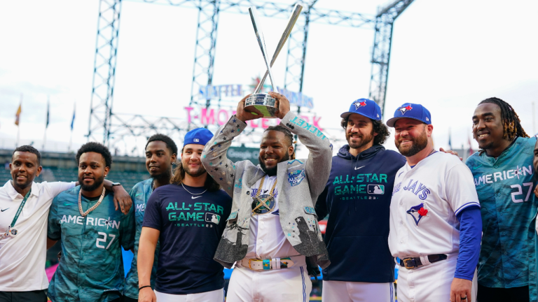 American League's Vladimir Guerrero Jr., of the Toronto Blue Jays, holds his trophy surrounded by teammates after winning the MLB All-Star baseball Home Run Derby in Seattle, Monday, July 10, 2023. (AP)