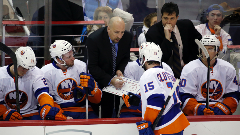 FILE -New York Islanders assistant coach Brent Thompson, left, directs right wing Cal Clutterbuck (15) with head coach Jack Capuano at right, in the third period of an NHL hockey game against the Washington Capitals, Tuesday, Feb. 4, 2014, in Washington. The Anaheim Ducks have added veteran American Hockey League head coach Brent Thompson to Greg Cronin's staff. The Ducks announced the hiring on Tuesday, July 11, 2023, (AP Photo/Alex Brandon, File)